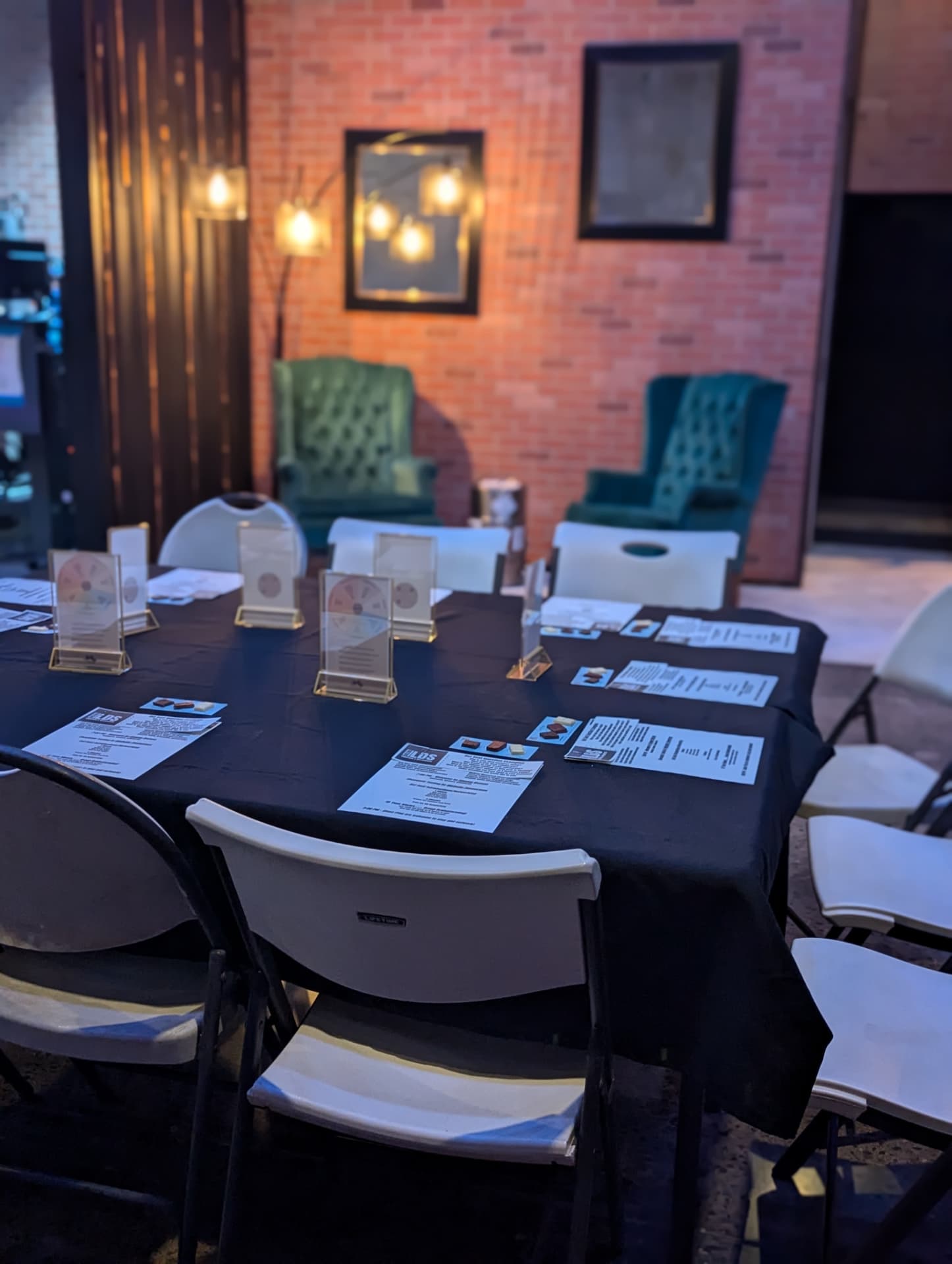 Exposed brick wall, Edison bulbs, and seating inside The Shop